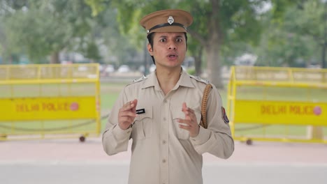 happy indian police officer talking to someone