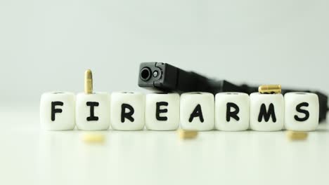 firearms word spelled with letter blocks, featuring a handgun and ammunition