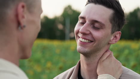 two men talking and kissing