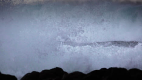 Huge-waves-roll-in-and-crash-against-a-rocky-shoreline