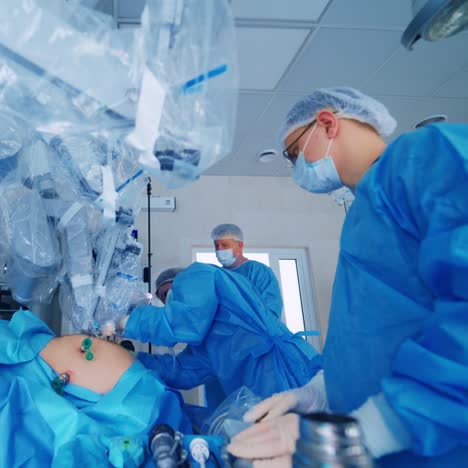 da vinci surgical system. group of doctors perform an operation to a patient.