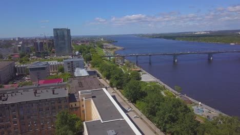 aerial view of city by the river with park and bridge