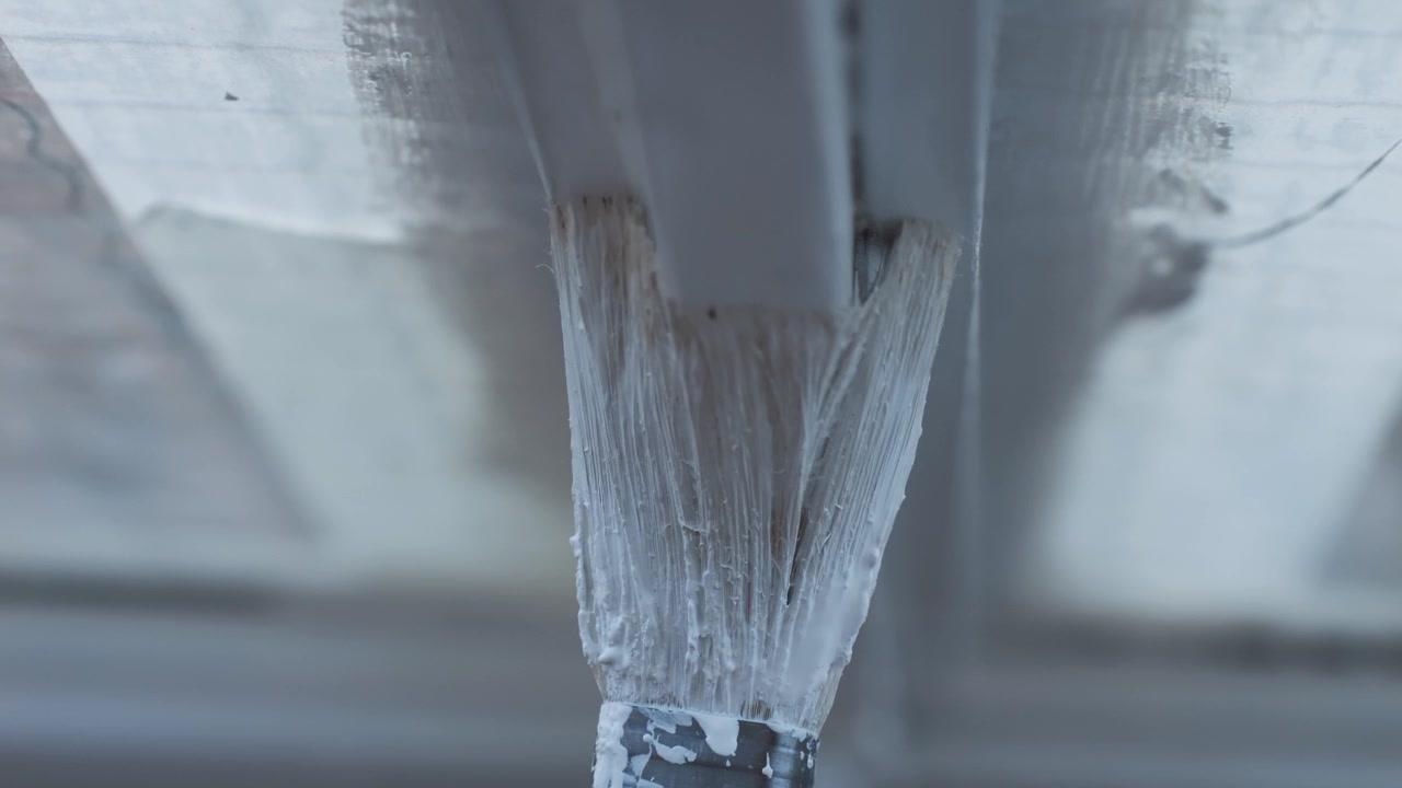 Close-up of Painting a Window Frame with White Paint