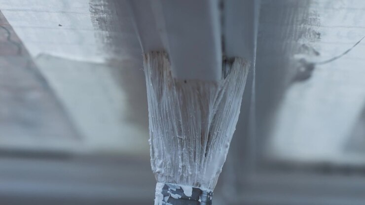 Close-up of Painting a Window Frame with White Paint