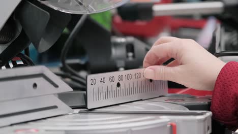 girl in a shop buys a stationary, electric circular saw