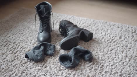 black boots and socks on a carpet