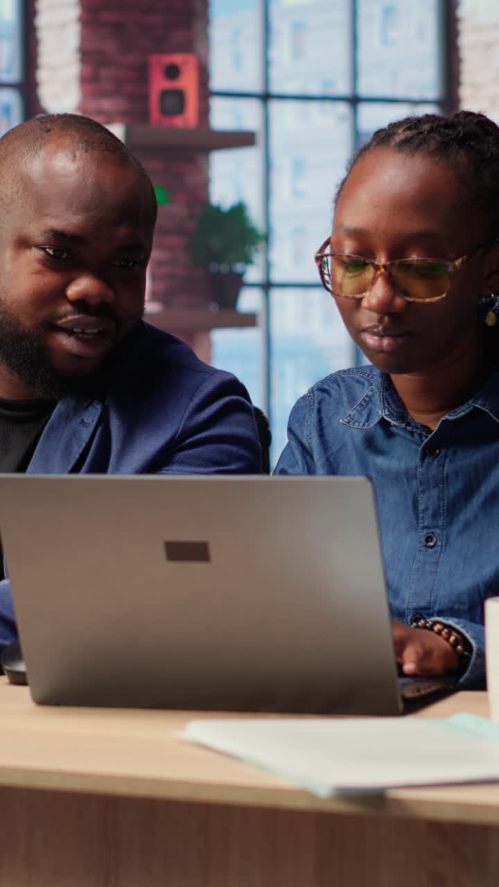 African American Business People Collaborating on Laptop in Modern Office