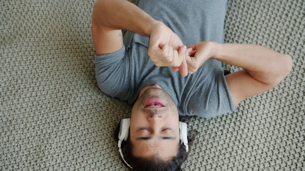 Man Relaxing and Listening to Music on the Floor