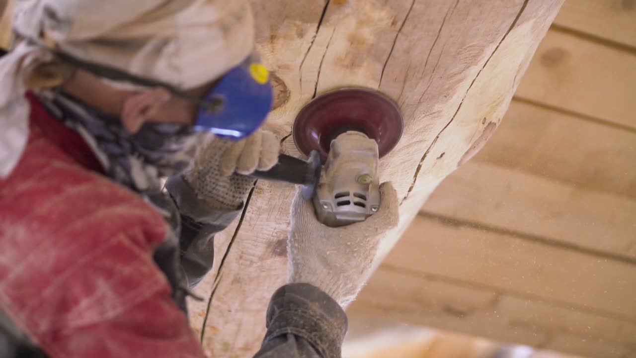 Carpenter Sanding a Wooden Beam