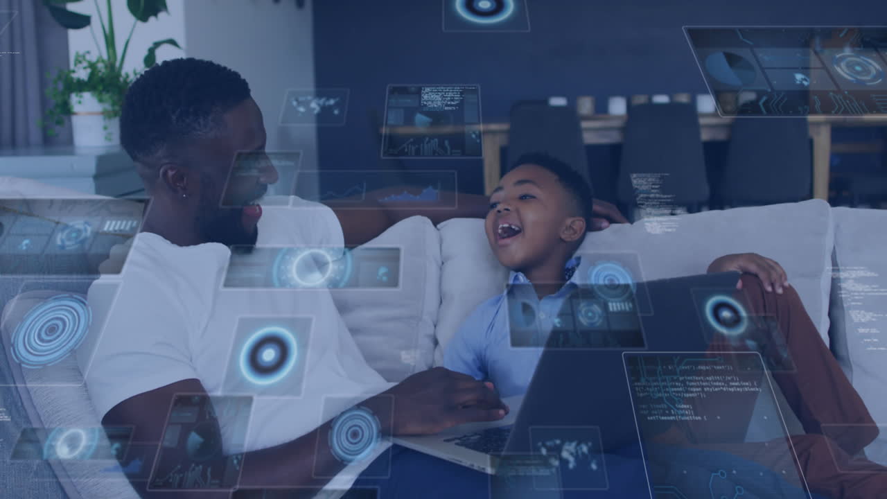 Animation of data processing over african american father and son using laptop laughing at home
