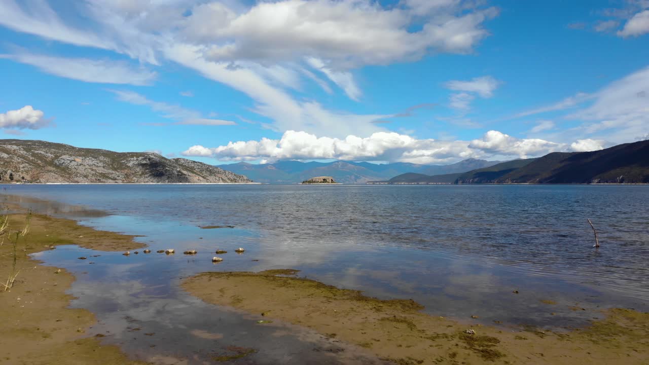 природное озеро преспа в высоких балканских горах с маленьким островом посередине осенью