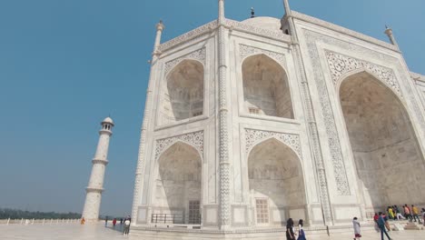 people visiting the taj mahal. panning shot of the ivory-white marble facade