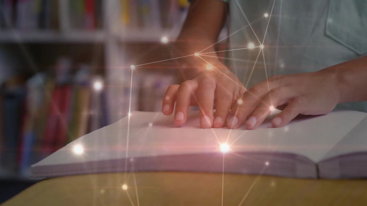 Hands positioning fingertips on Braille book while network overlay growing, showing knowledge flow