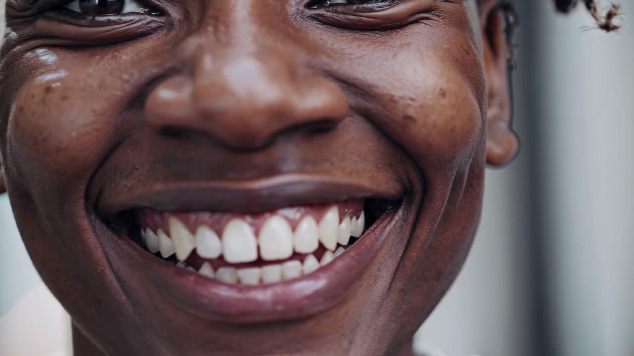 Close-up video of a joyful person smiling, capturing emotion and detail