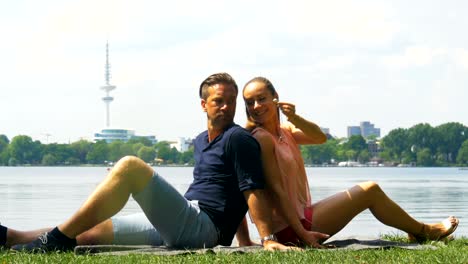 - un fin de semana de pareja relajándose a la orilla del río y escuchando música con auriculares