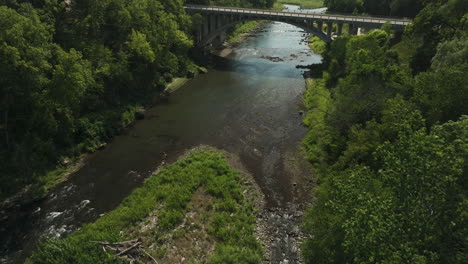 aerial view of zumbro river with arch bridge revealed