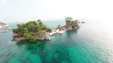 FPV-drone-flying-towards-and-over-a-white-Church-on-a-small-island-in-Greece