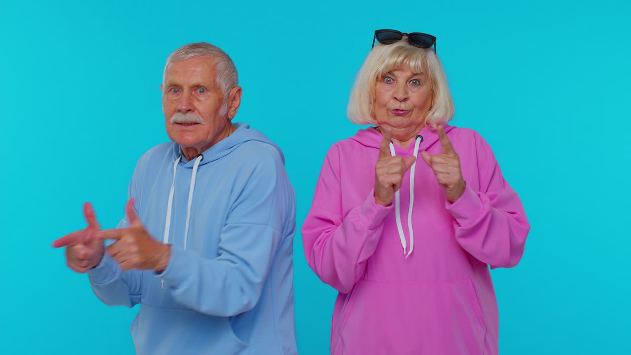 Funny Senior Couple Pointing at Camera