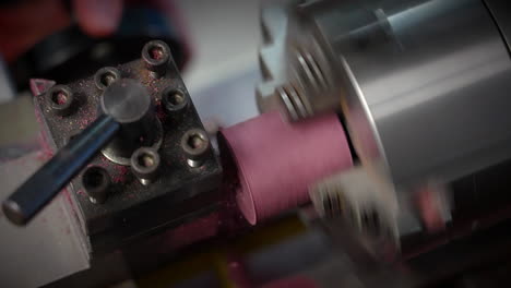 lathe machine shaping piece of rotating wood material in manufacturing industry. closeup shot, slow motion
