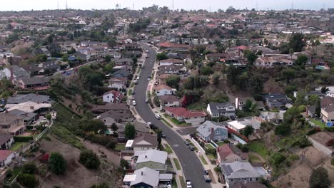 baldwin hills winding road through suburban residential neighbourhood estate aerial rising forward view