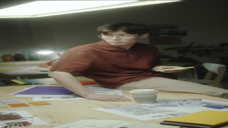 a young man working on a design project at night