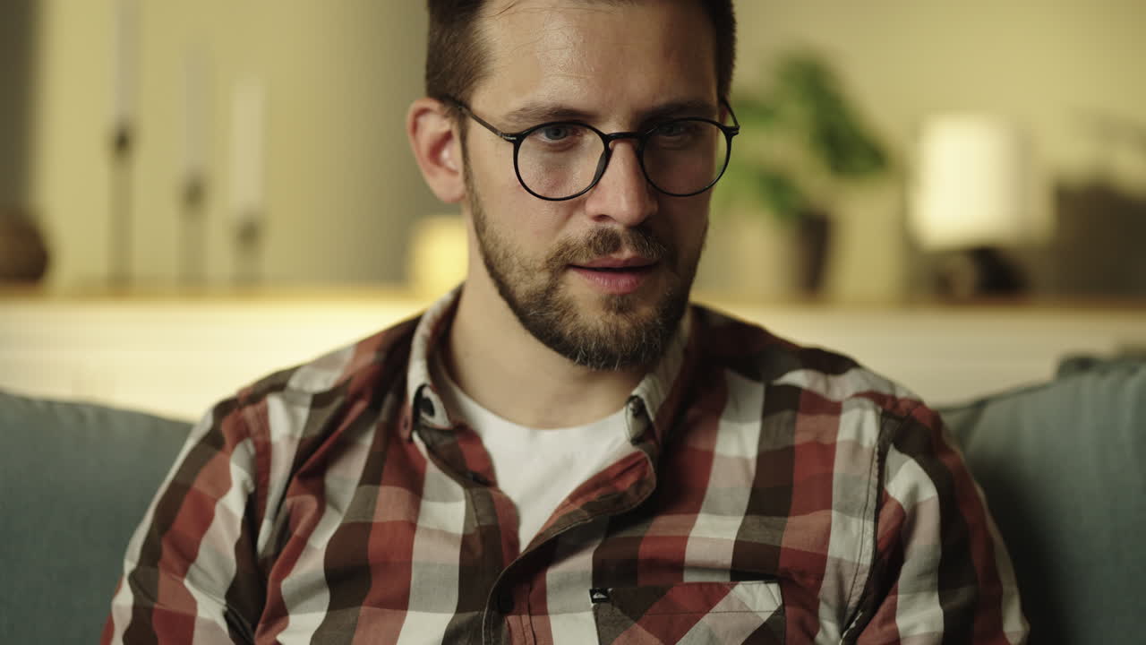 Man with glasses and beard wearing a plaid shirt