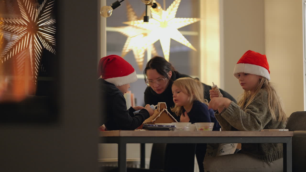 Happy family preparing christmas at home by the fireplace