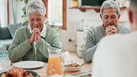 Senior-couple,-home-and-praying-for-food-at-dinner