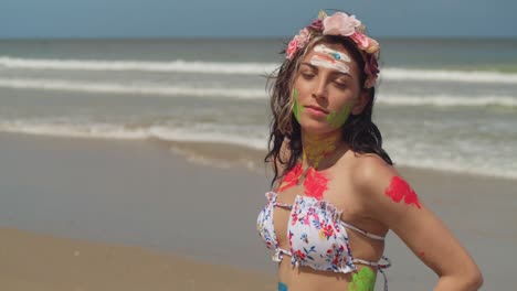 on the sun-drenched beaches of the caribbean, a young girl in a bikini added a splash of color with her artistic body paint close up