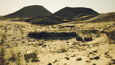 a desert landscape with hills in the background