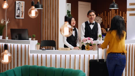 front desk team greeting guest at five star hotel reception