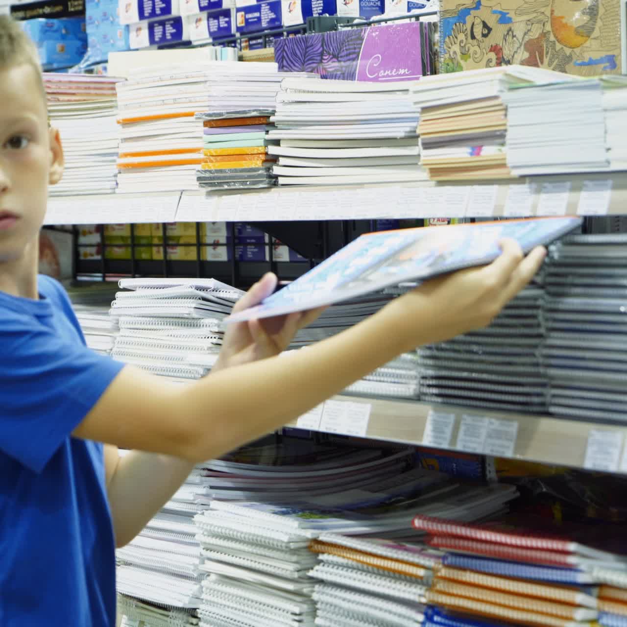 Vinnitsa, Ukraine - August, 2018: Boy choosing buying stationery in store preparing for first day in school.