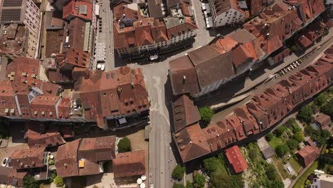 drone footage showing river bridge, red-roofed buildings, and historic streets in aarau, kanton aargau, switzerland