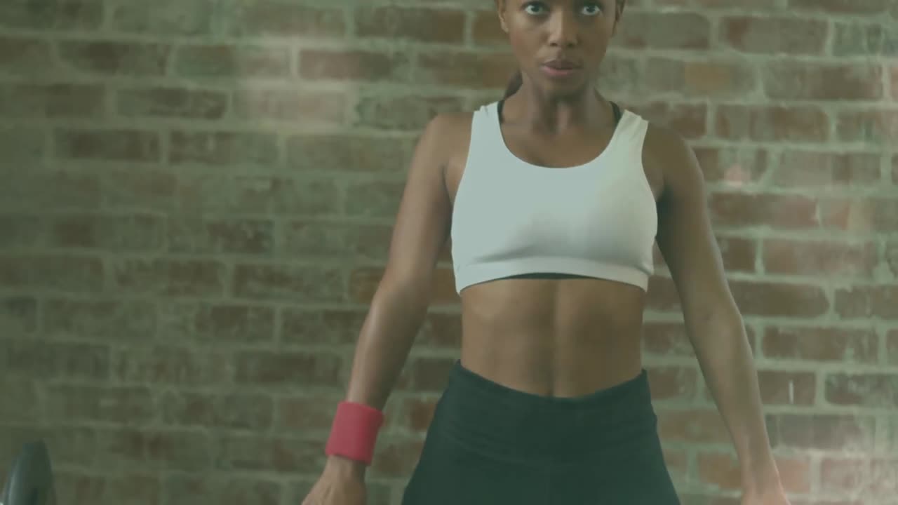 Animation of light spots over african american woman lifting weights at gym