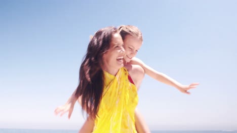 Mother-and-daughter-playing-on-the-beach