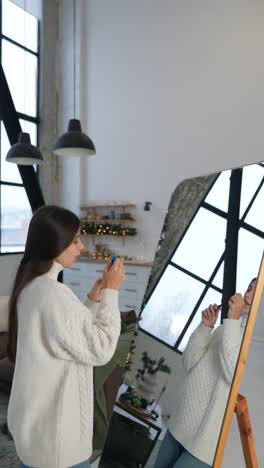 woman applying makeup in front of a mirror