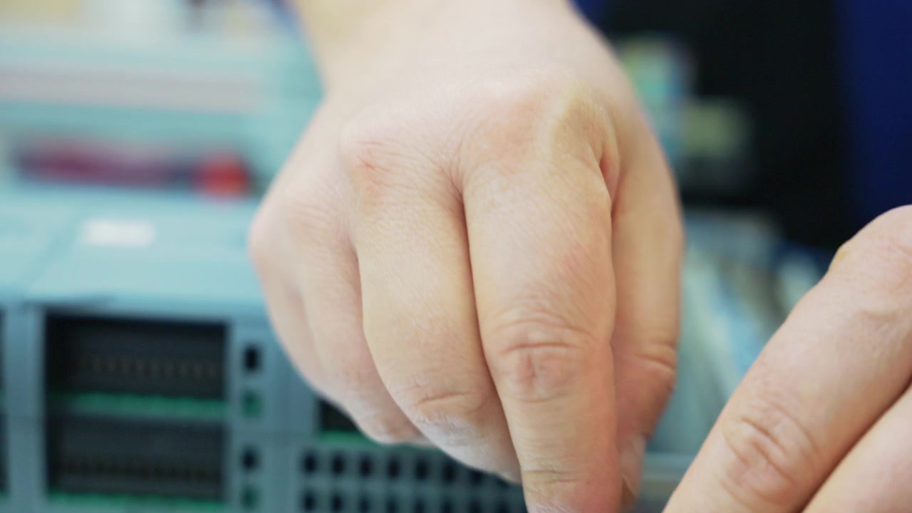 Close Up of Electrician Hands Organizing and Tying Cables