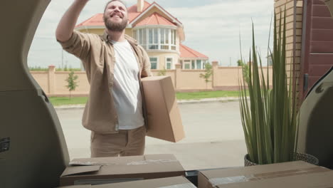 happy couple unpacking belongings and moving house