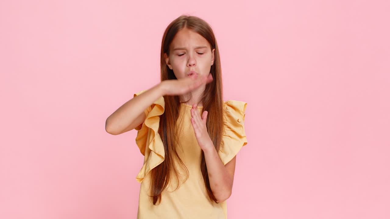 Child girl kid making timeout hand gesture seriously looking at camera asking for pause short break