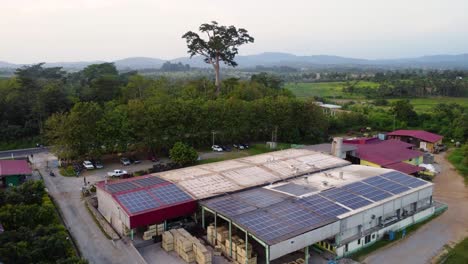 aerial view of warehouse with solar panels on roof in rural africa