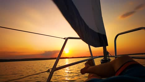 Close-Up-Shot-Relaxed-Traveler-Man-Legs-on-Motorboat-on-Beautiful-Island-and-Mountain-Carefree-Concept