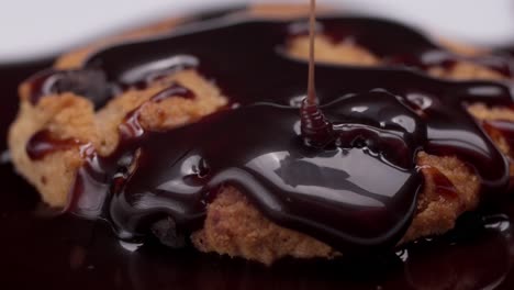 chocolate syrup dripping over a warm cookie, creating a glossy and indulgent look