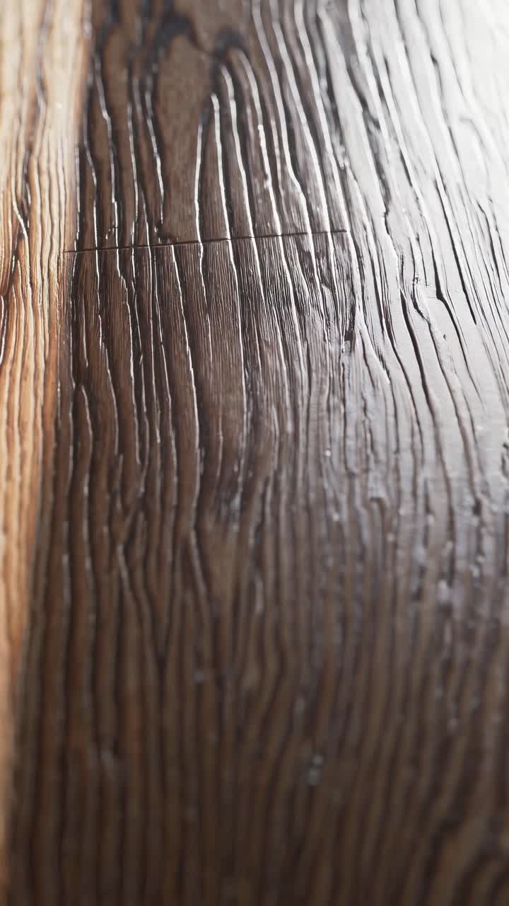 Close-up video shot of textured wooden flooring, highlighting the intricate grain patterns