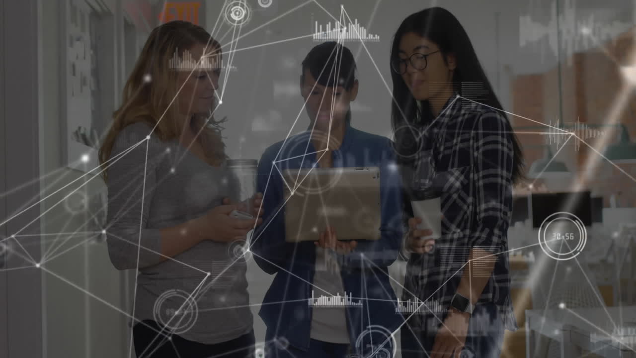 Three female colleagues collaborating around tablet in tech office showcasing animated data charts