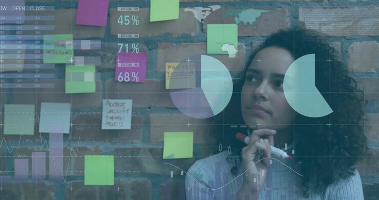 Business analyst studying sticky notes, following data overlays appearing and writing insights