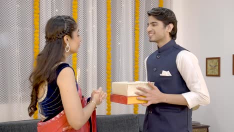 Indian-girl-giving-gift-boxes-to-her-partner