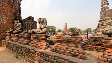 ruins of pagoda and buddha statues in ayutthaya