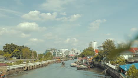 Looking-at-the-boot-on-a-bridge-in-Bangkok-city