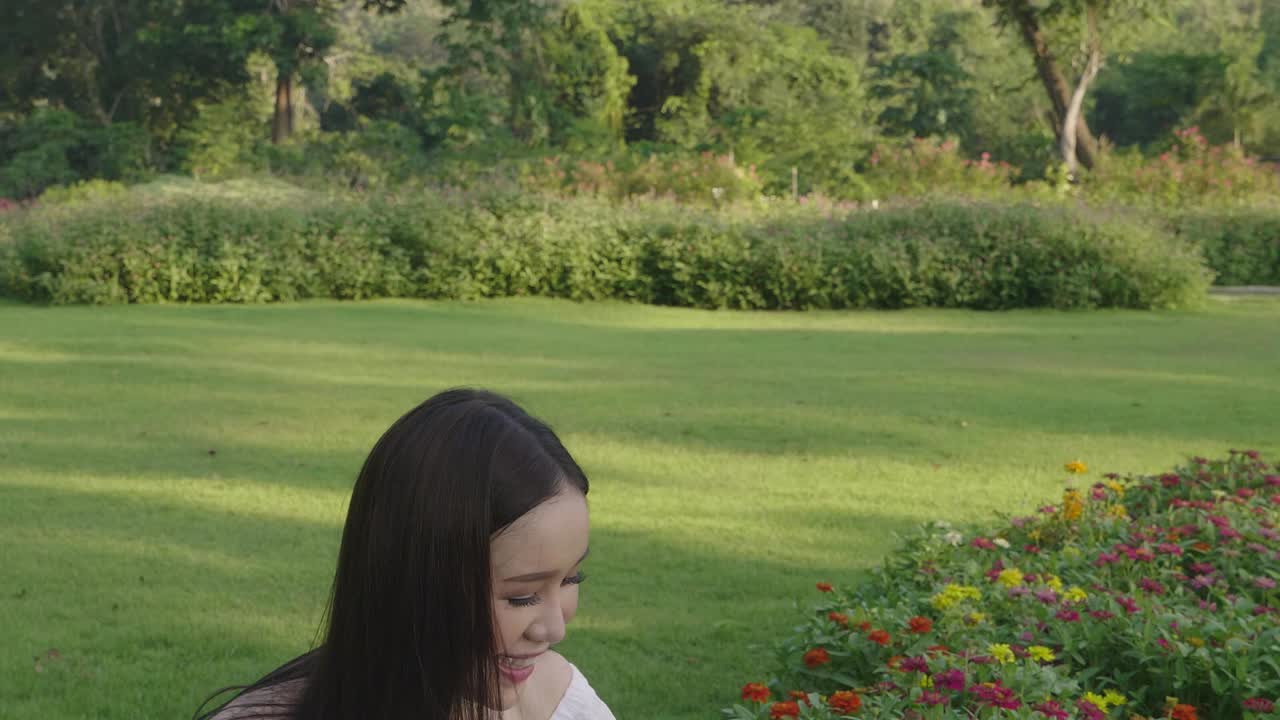 Beautiful Asian Girl Touching Flower