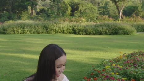 beautiful asian girl touching flower
